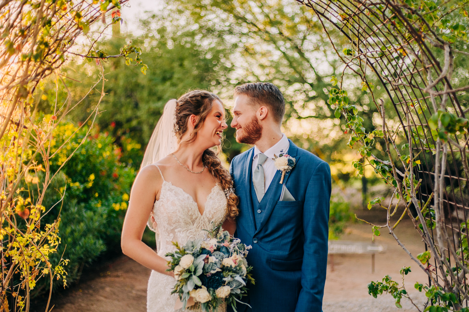 Glover-Ranch-Wedding-Tucson-Photographer-Marana-Wedding-Venue-Wedding-Photographer-Near-Me-Cute-Bride-And-Groom-Portraits-Smiling-Looking-At-Each-Other-Secret-Garden-Wedding-Photos